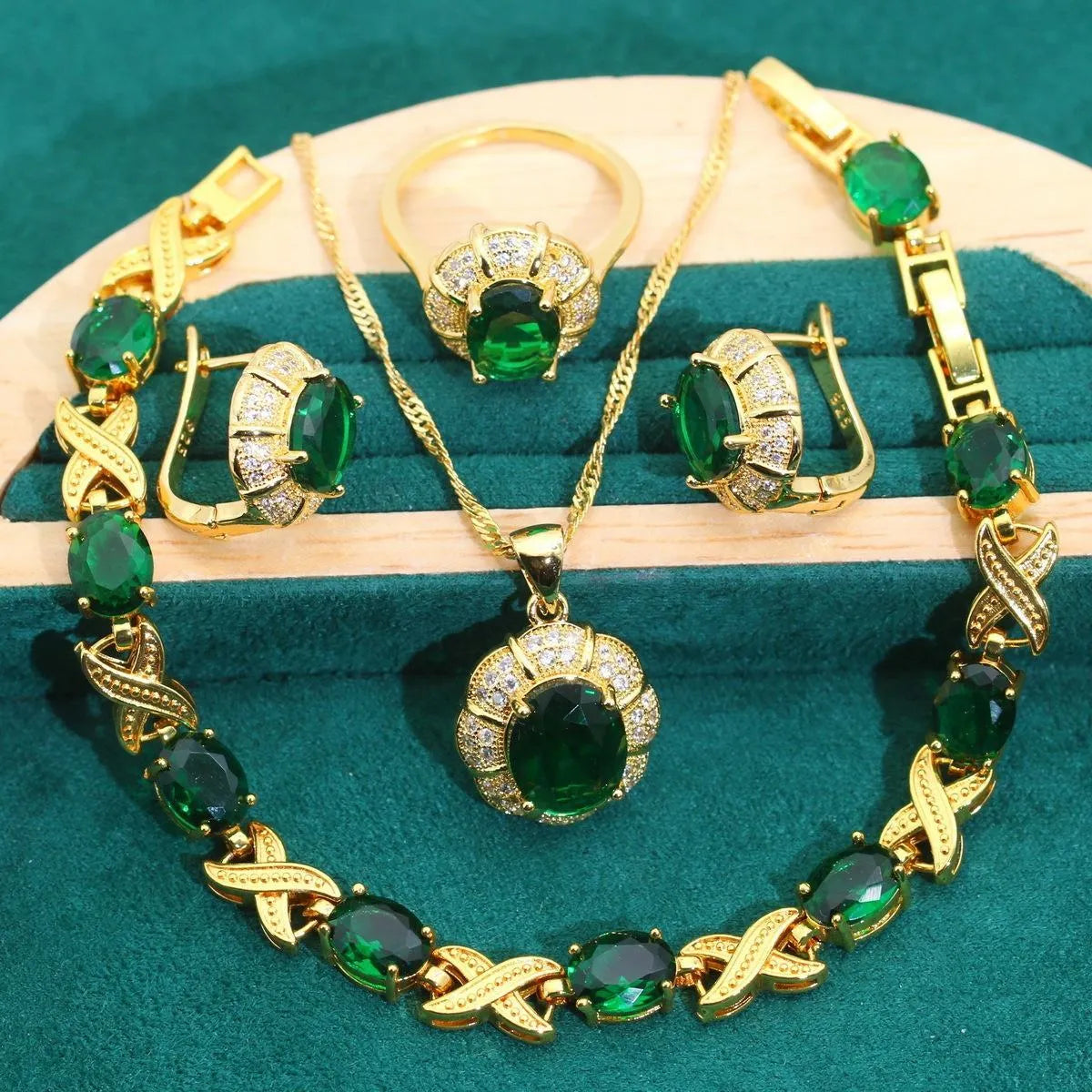 18k gold plated four-piece jewellery set with synthetic cubic zirconia stones in Raytheon cut, showing necklace, earrings, ring, and bracelet