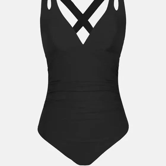 Solid colour one-piece triangle bikini swimsuit with cross shoulder straps on a model.