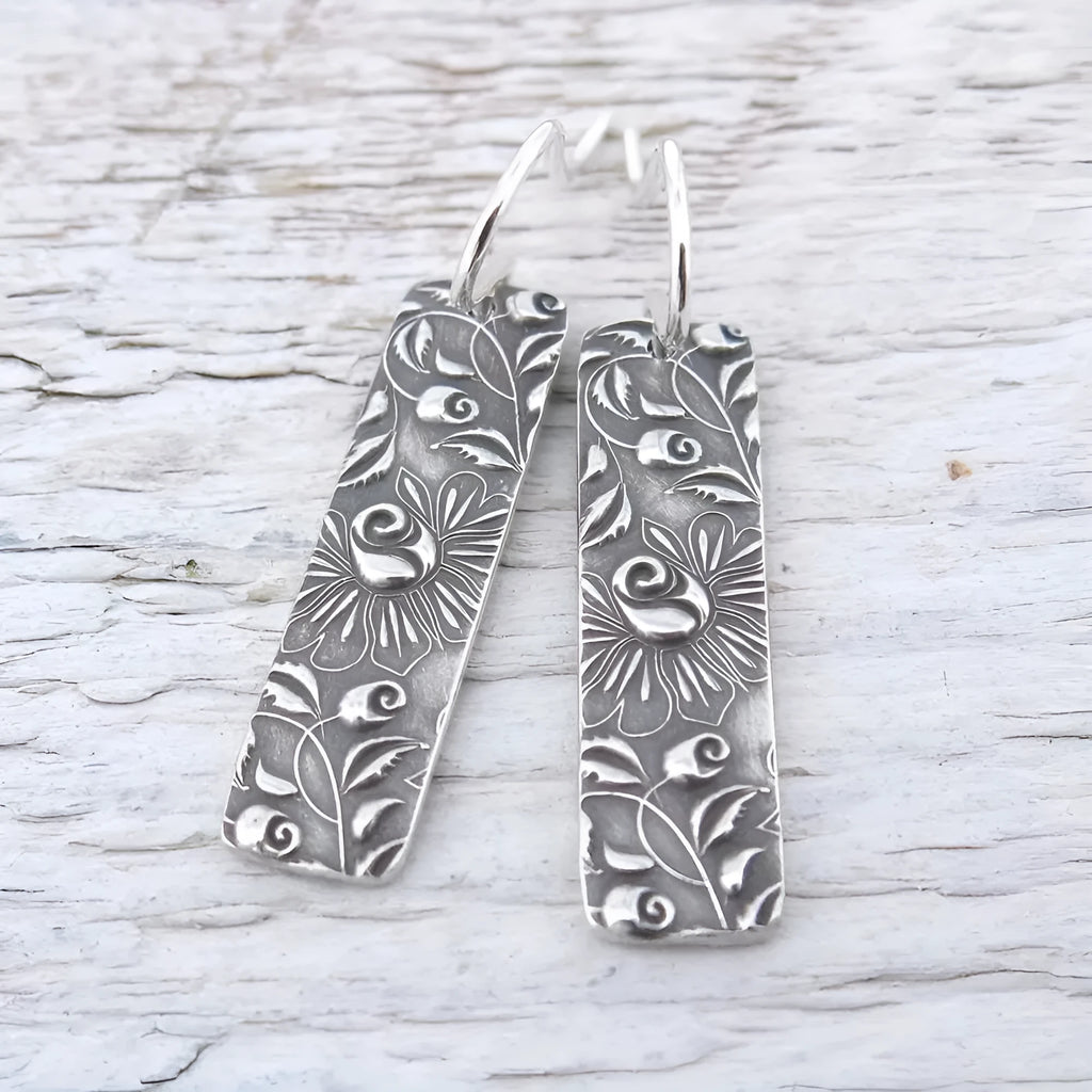 Silver geometric long earrings with carved vine detailing measuring 20 cm
