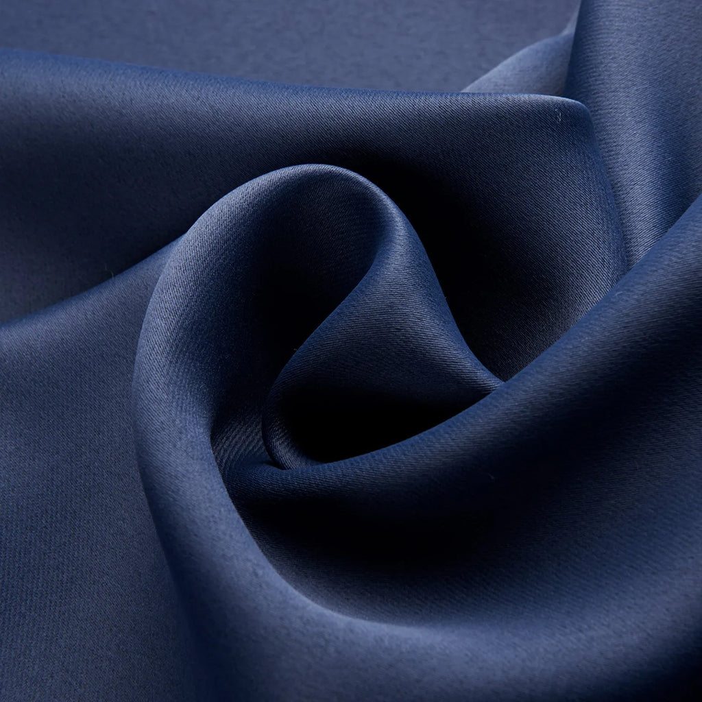 Navy blue blackout curtains with shading cloth fabric in vertical design, showing printed surface and perforated top for hanging