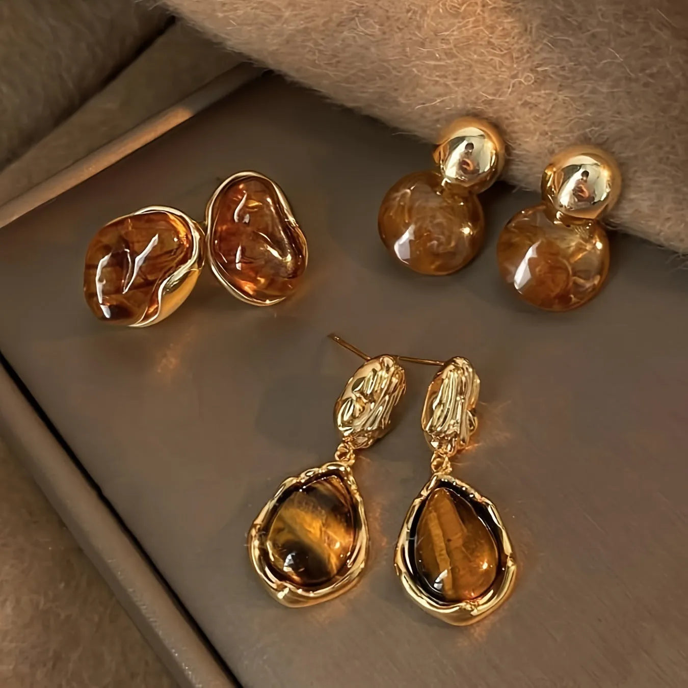 Handmade holiday earrings with three geometric styles: round, irregular, and water drop designs with tassel elements