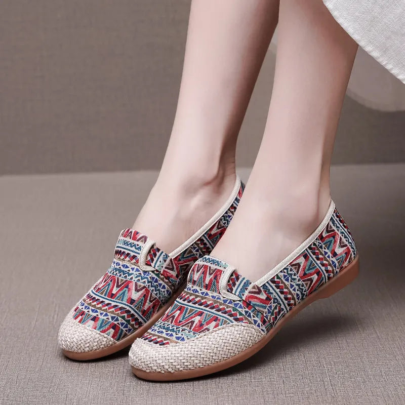 Women's ethnic style cloth shoes with flat heel, colour stitching, and a shallow mouth design.