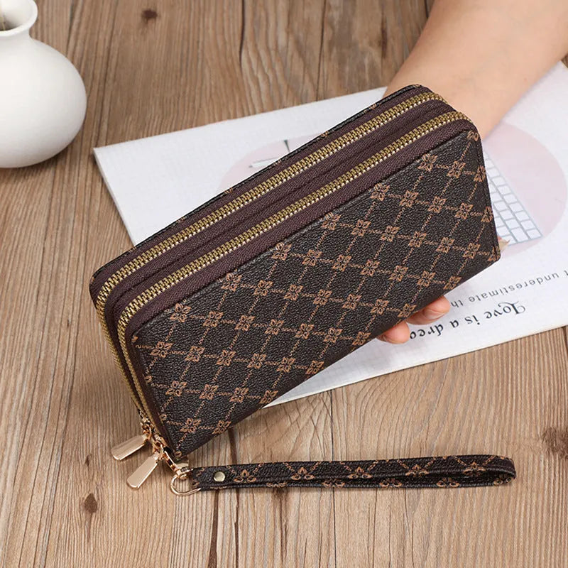 Retro style long wallet clutch in PU leather with a print design, shown in black colour.