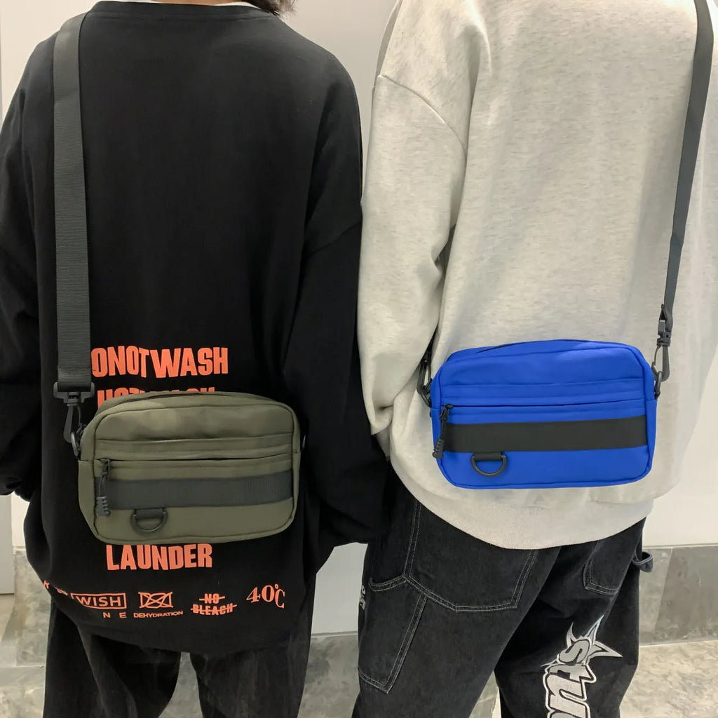 Men's solid colour nylon crossbody messenger bag with visible sewing thread detail.