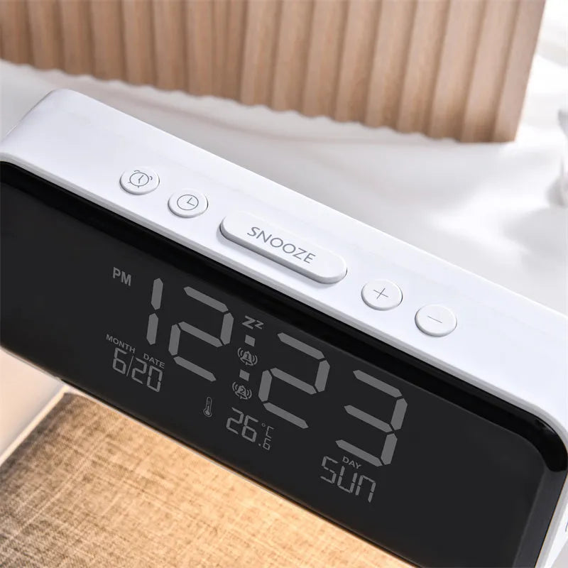 White bedside lamp with integrated wireless charging pad, LCD alarm clock screen, and touch-sensitive dimming controls.