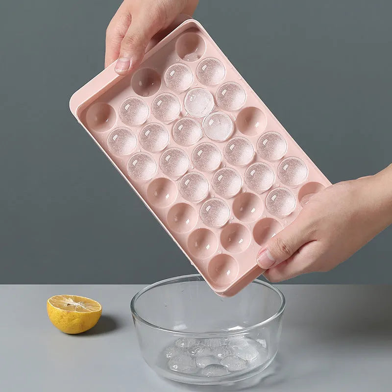 Sky blue and pink 3D round ice ball mould trays with 18 and 33 grid options for home bar use.
