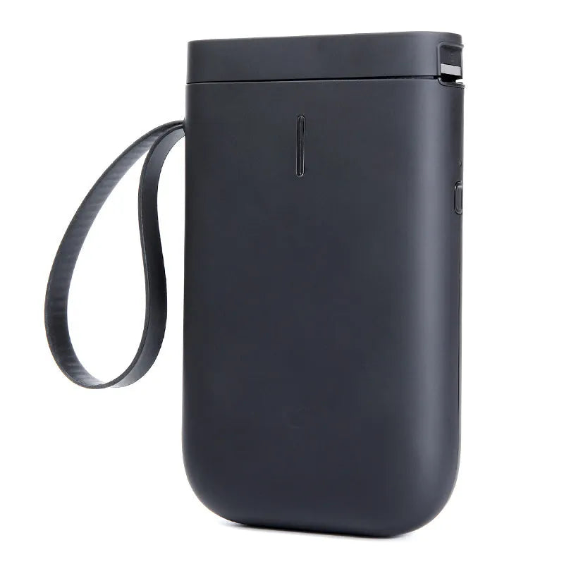 D11 compact Bluetooth thermal label printer in black on a desk next to a smartphone showing the control app.