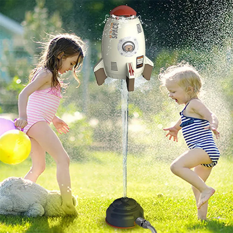 Yellow water pressure rocket launcher toy for kids outdoor garden play on a green lawn.