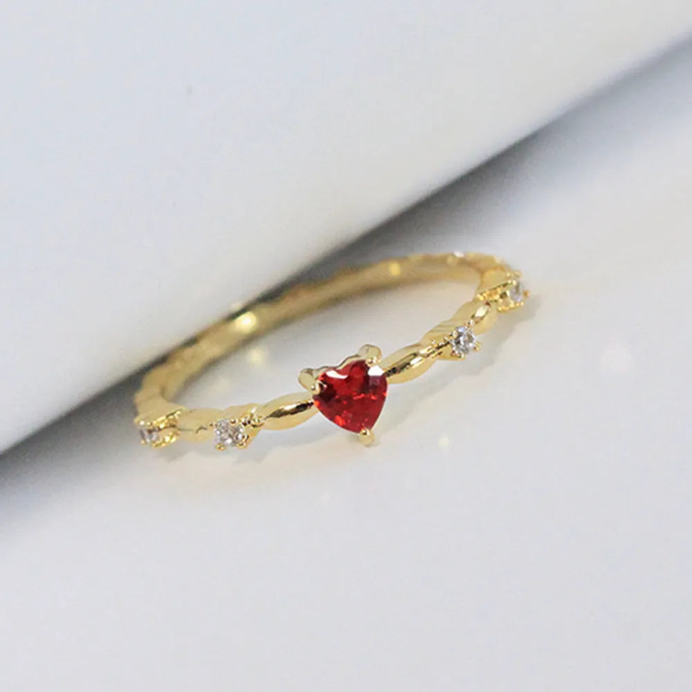 Gold and silver electroplated peach heart ring with zircon stones on a copper base.
