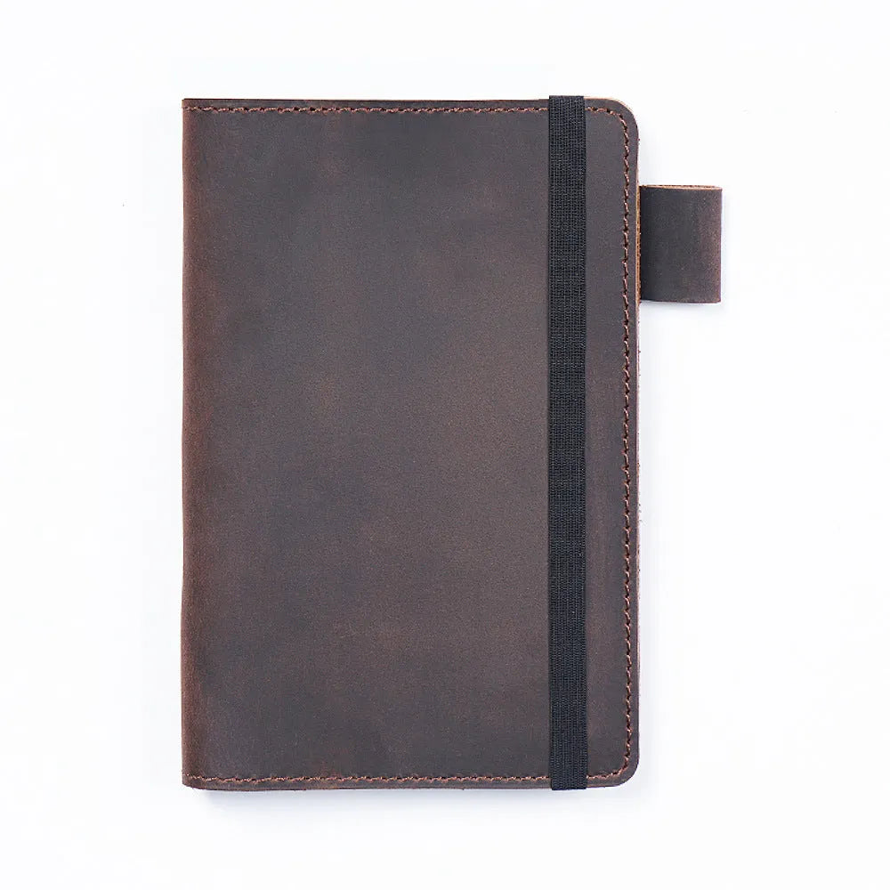 Handmade leather kraft notebook open showing wood-free paper with dark green cowhide cover
