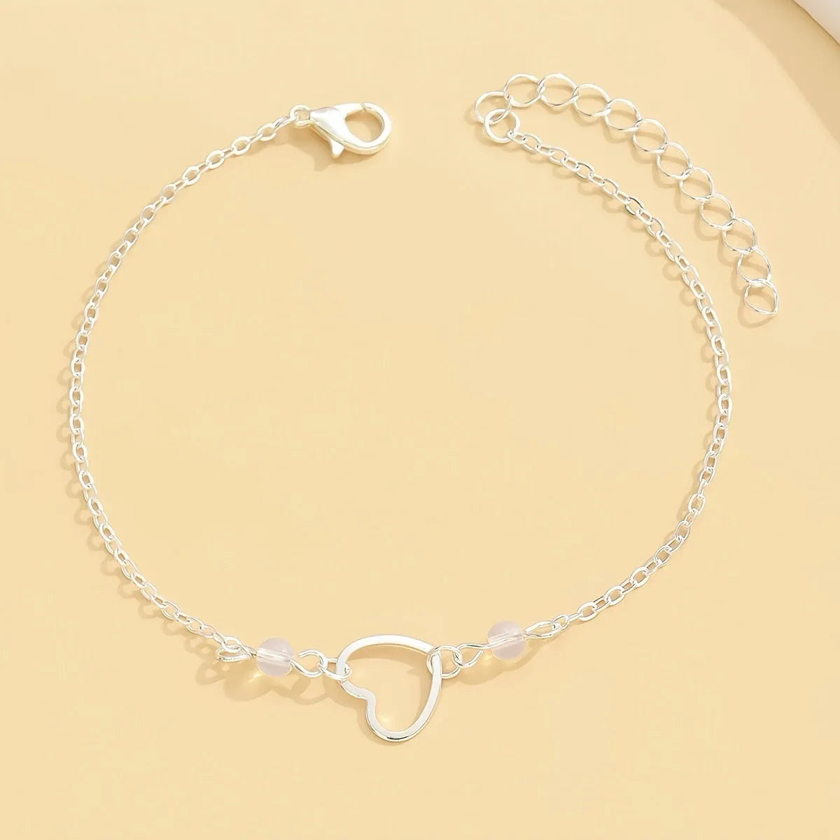 Adjustable heart-shaped pendant anklet in gold or silver finish with geometric design