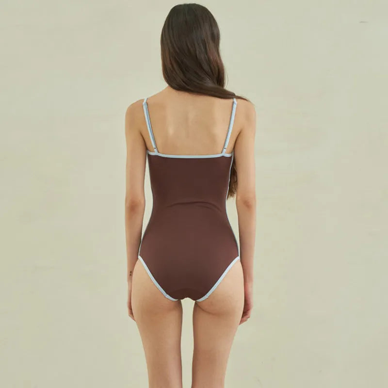 Brown triangle one-piece swimsuit for women with nylon fabric and sizes M, L, XL.