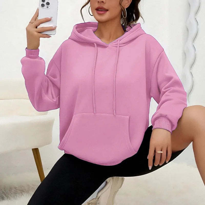 Women's loose grey sweatshirt with long sleeves and a front drawstring pocket, shown in a relaxed fit.