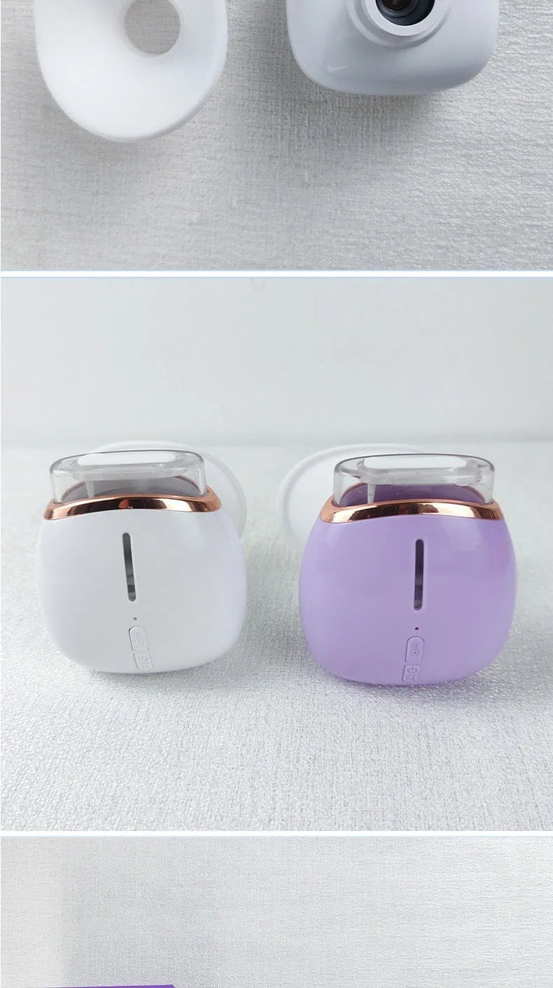 White and purple personal eye humidifier device with USB charging cable on a table.