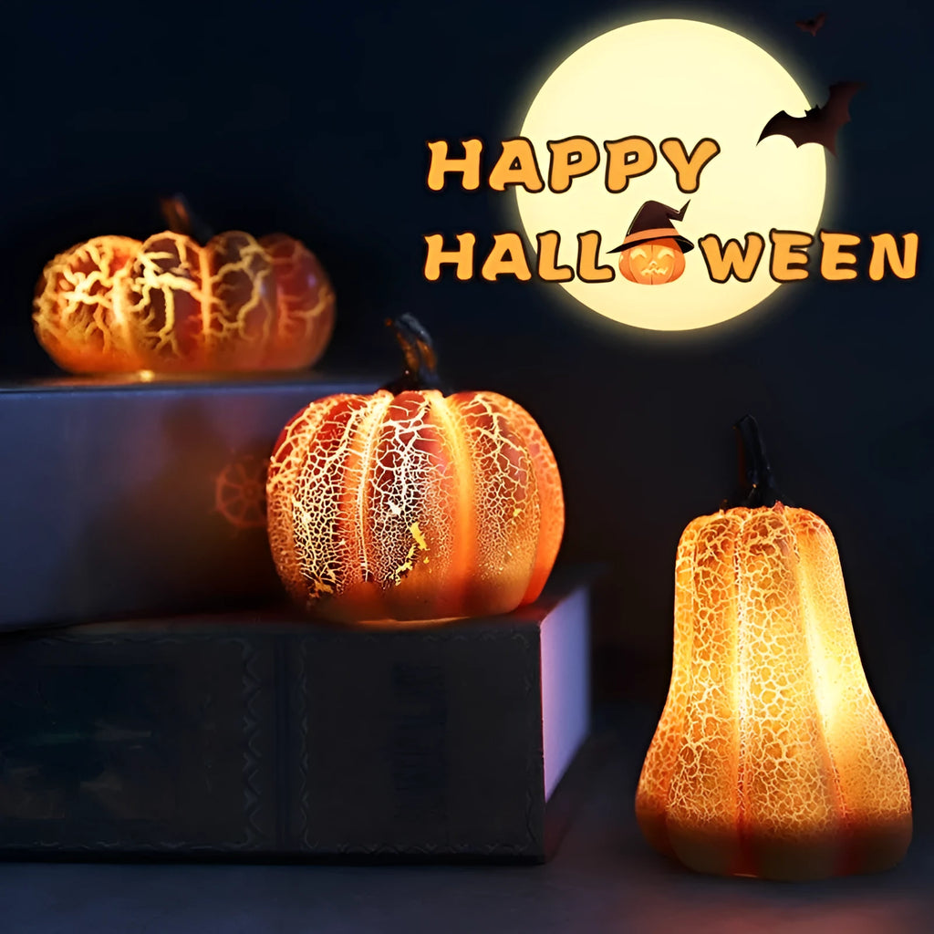 Set of three resin Halloween pumpkin lanterns with LED candle lights in short, medium, and long sizes.