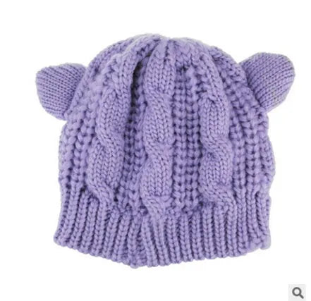 Hand-knitted wool cat ear beanie in red colour showing 3D ear design and textured wool material
