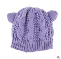 Hand-knitted wool cat ear beanie in red colour showing 3D ear design and textured wool material