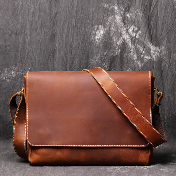 Vintage brown men's shoulder bag made of cowhide leather with adjustable strap and multiple internal pockets.