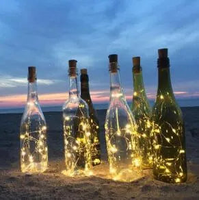 Bendable copper wire LED string lights wrapped around a wine bottle with 20 warm white LEDs glowing