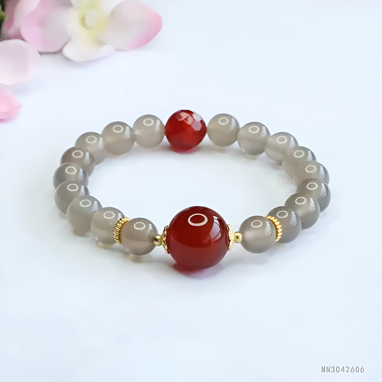 Natural smoky purple and red agate bracelet with 8mm geometric beads on a wrist.