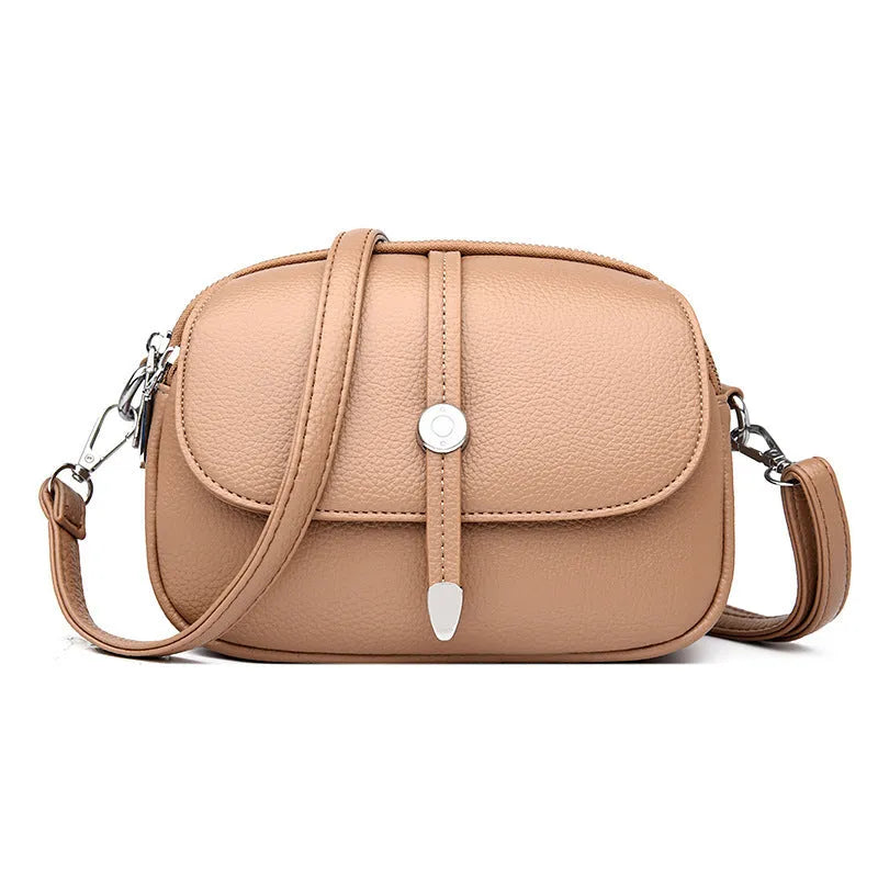 Women's soft PU oval crossbody shoulder bag with sewing thread detailing in dark brown