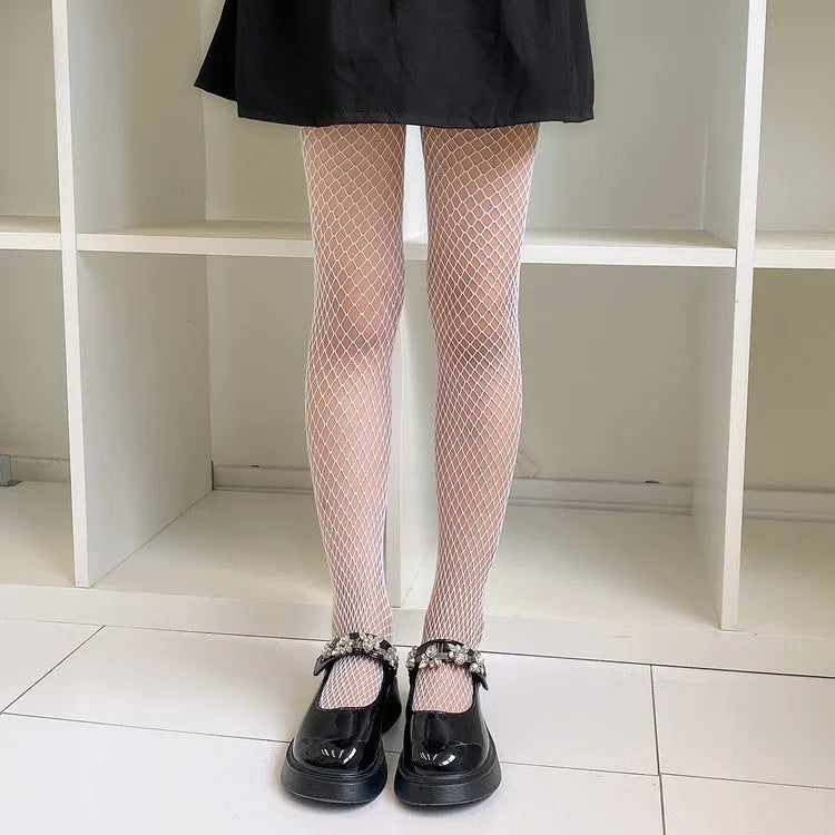 Women's mesh stockings showing large, medium and small net patterns in black and white colours on leg