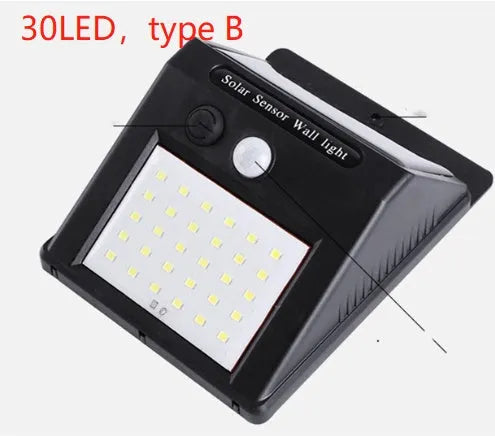 Solar-powered outdoor garden lamp with LED lights and a motion sensor on a stake.