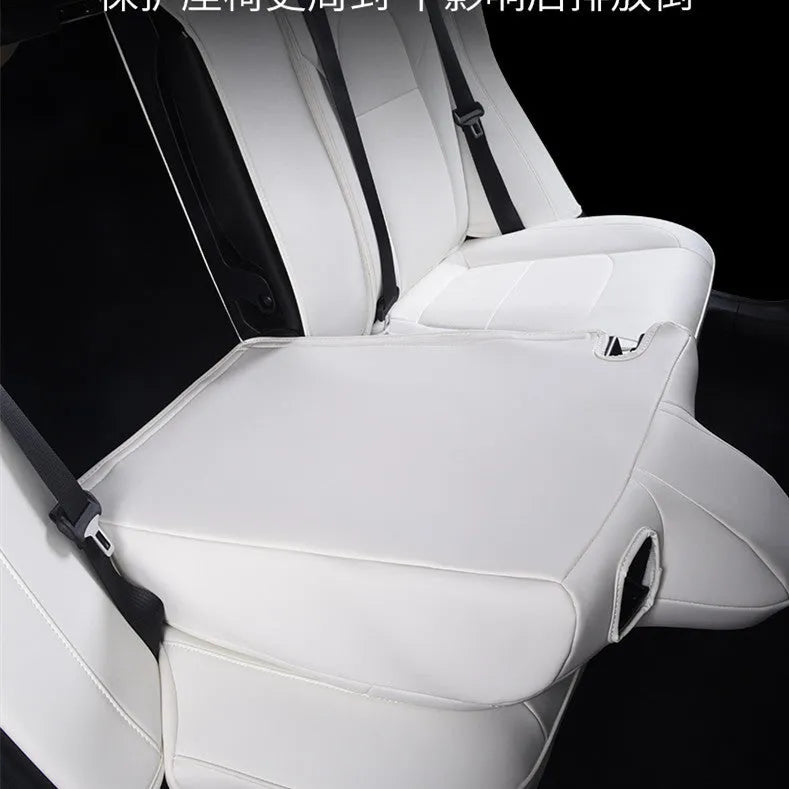 Black and white PVC car seat covers fitted on Tesla Model 3 and Y front and rear seats.