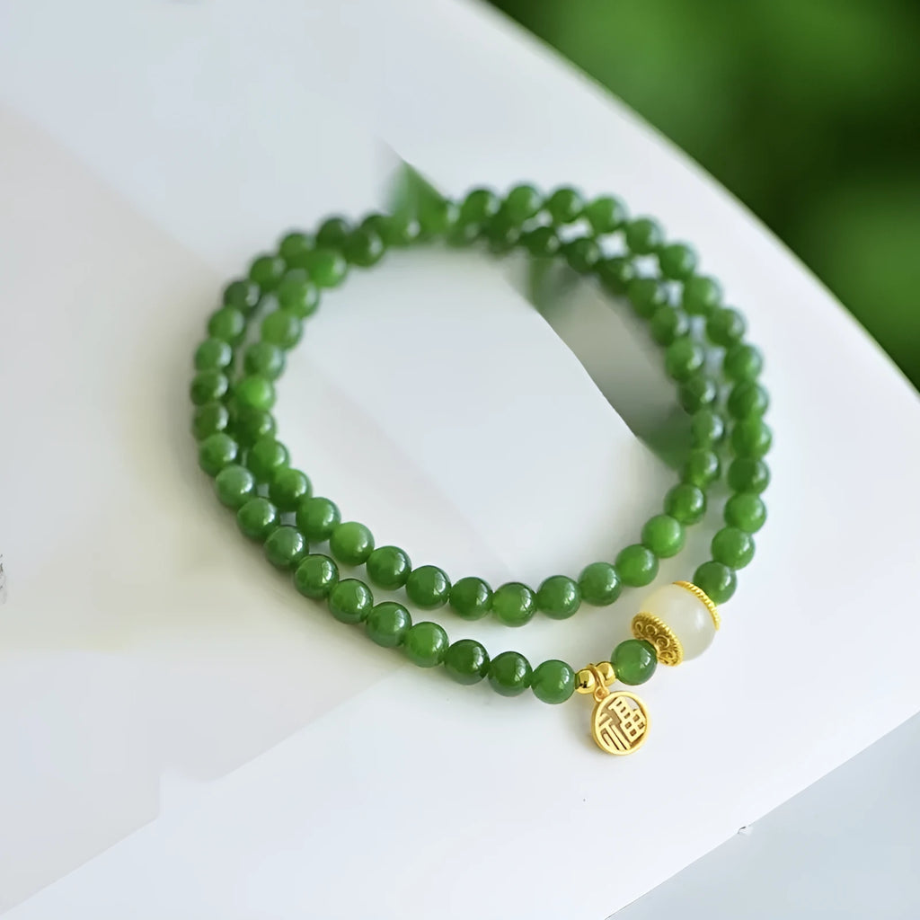 Women's double circle bracelet with natural Hetian jade beads and a central fu character charm.