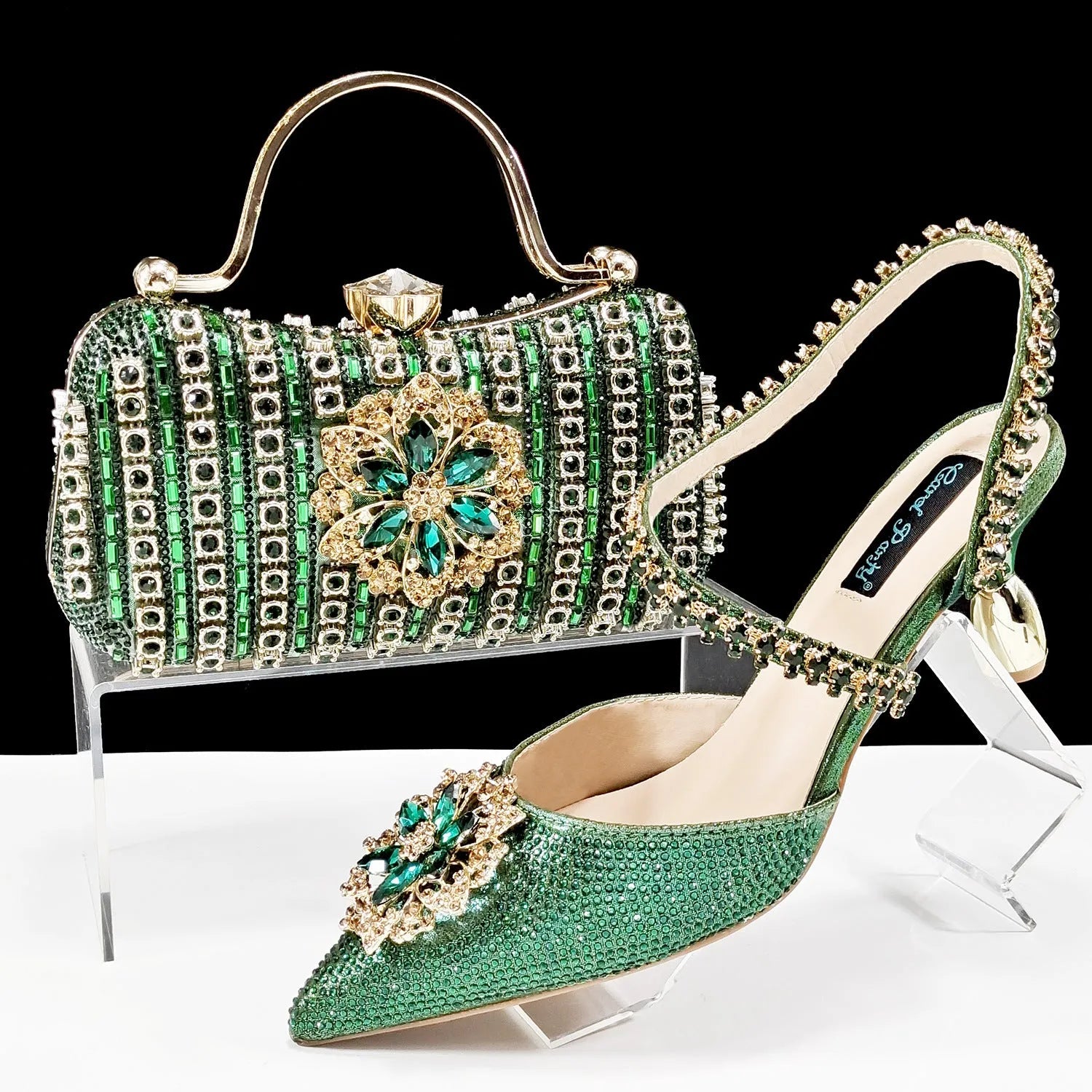 Women's black high-heel shoes with decorative ankle chain featuring floral rhinestone accents and matching clutch bag