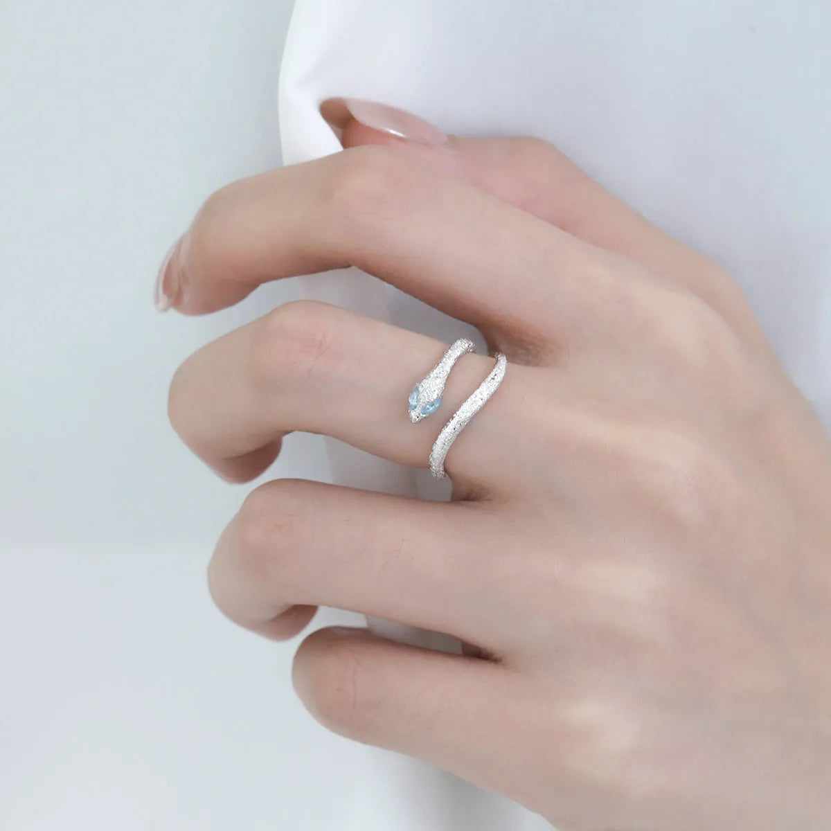 Adjustable silver snake ring with electroplated platinum colour finish and detailed scale texture