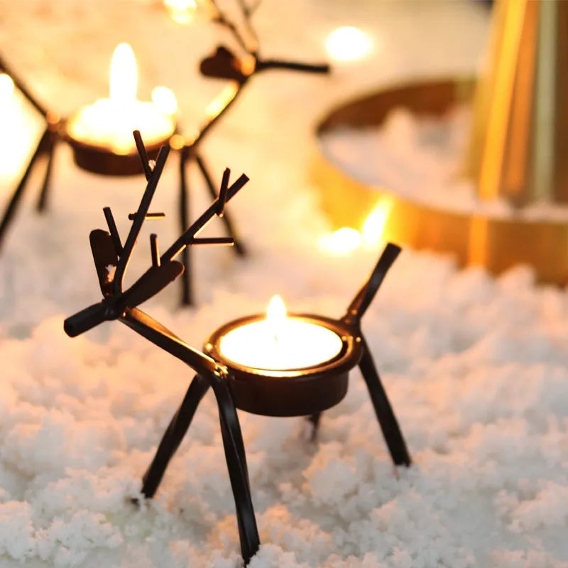 Black iron Christmas deer candlestick holder with Santa and snowman designs, 15cm height