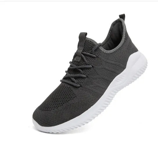Men's black and white mesh sneakers with round toe design and lace-up closure on neutral background