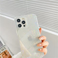 Laser-etched love design on transparent silicone iPhone case showing precise port cutouts
