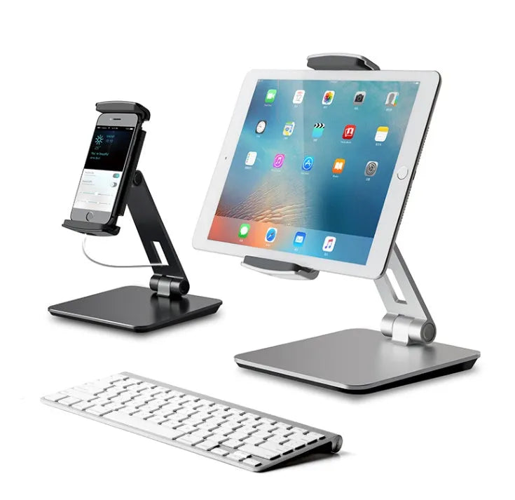 Silver foldable desktop holder supporting tablet with 360° rotation mechanism visible