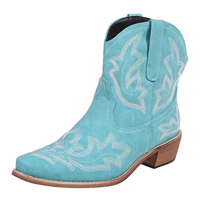 Women's blue cowboy boots with embroidery, wedge heel, and pointed toe on a neutral background
