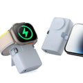 Compact white plastic wireless power bank with 5000mAh capacity, shown next to a smartphone.