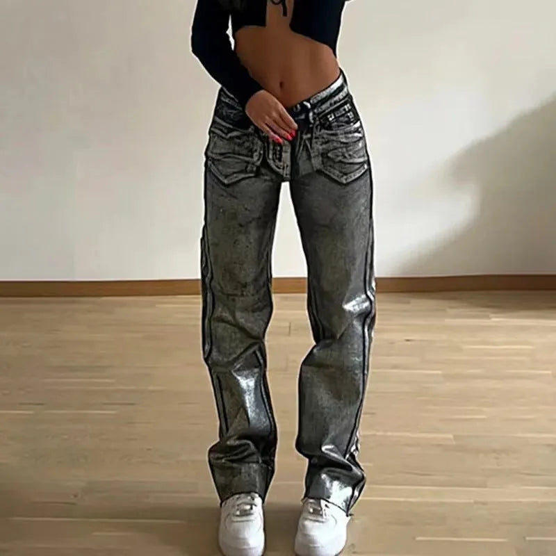 High waisted straight leg blue denim jeans with contrast stitching on a model.