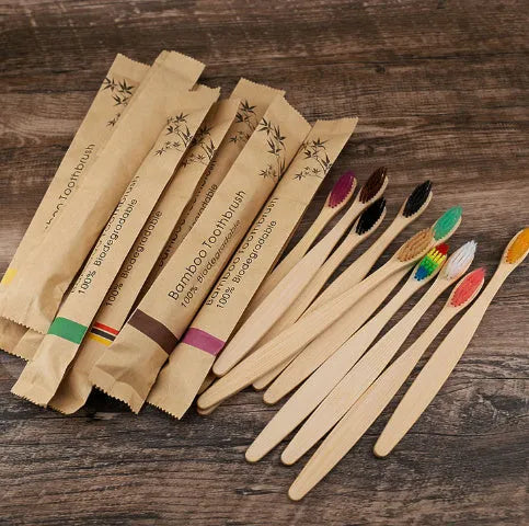 Set of 10 bamboo toothbrushes with charcoal bristles in various colours showing 17.5cm handles