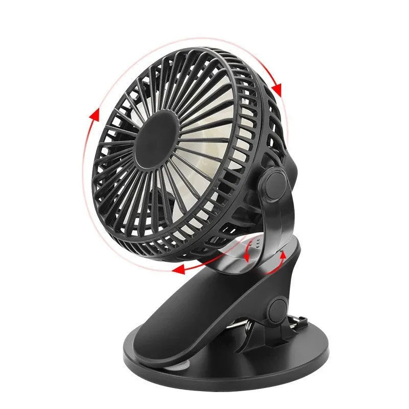 Small white clip-on personal desk fan with USB cable attached, shown clipped to a surface.