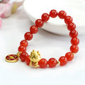 Close-up of a red agate bead dragon zodiac bracelet on a wrist, showing 8mm beads and Chinese style design.