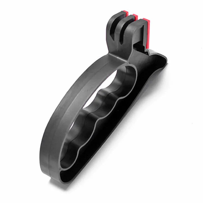 Black handheld tungsten steel knife and scissor sharpener on a kitchen counter