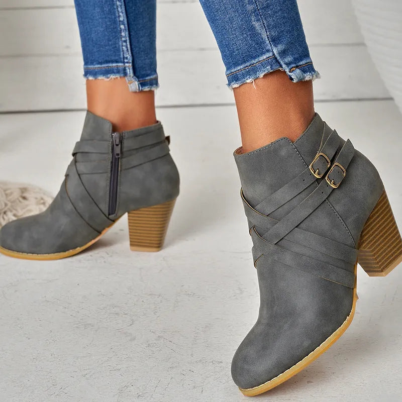 Short boots with 7cm heels in black, brown, or grey colours, showing side zipper and rubber sole
