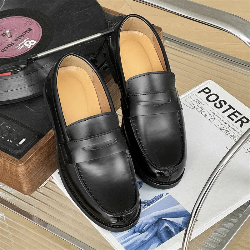 Black men's leather slip-on derby shoes on a white background