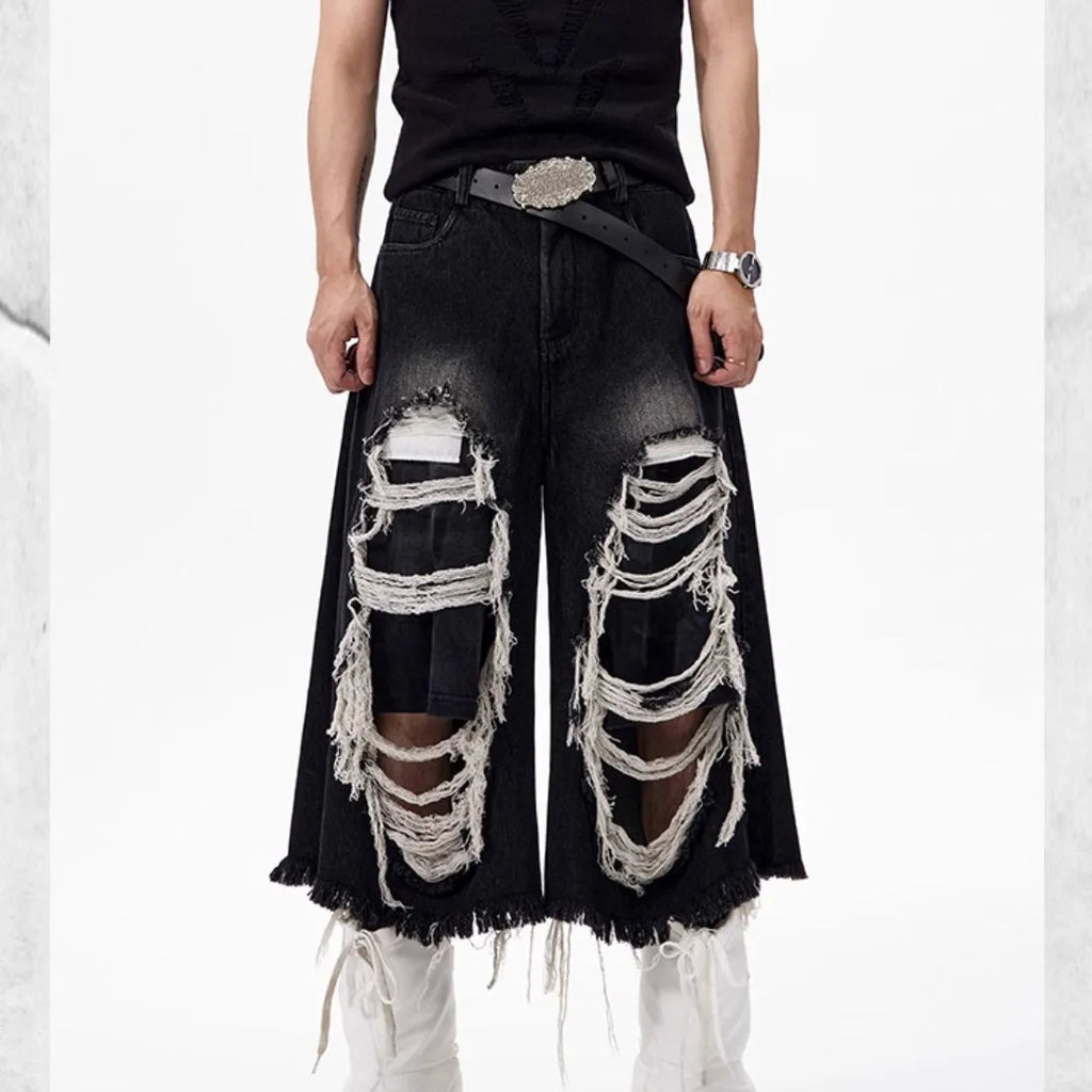 Black cropped wide-leg jeans with mid-high waist, showing loose fit and micro-elastic cotton fabric