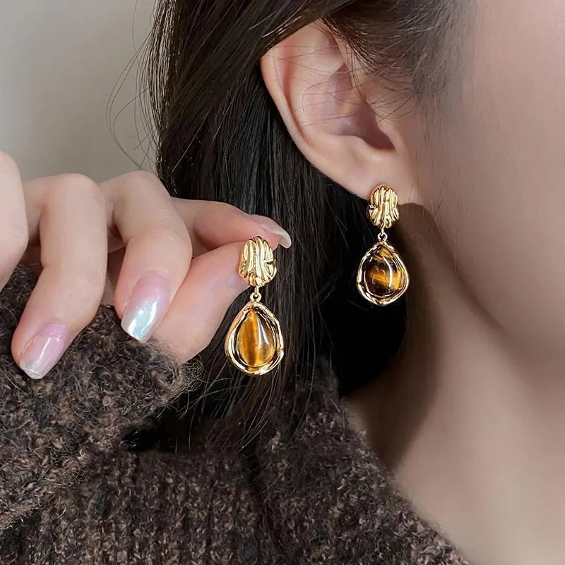 Handmade holiday earrings with three geometric styles: round, irregular, and water drop designs with tassel elements