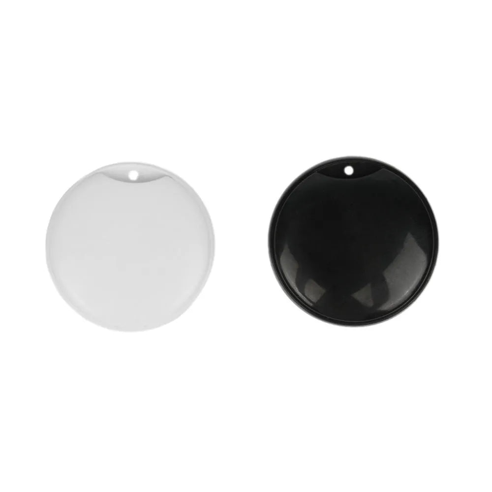 White or black GPS tracker device with hanging rope for attaching to pet collars or keychains, showing compact size of 32mm by 32mm by 9mm.
