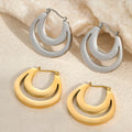 A pair of geometric minimalist French earrings in a round ring design, shown in both gold and steel metallic finishes.