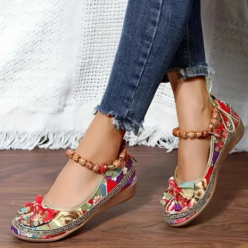 Black and red women's plus-size ethnic platform sandals with a cloth upper and elastic band.