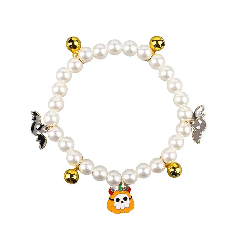 Halloween cat collar with simulated pearls and pumpkin designs in purple ghost, skull, and smiling motifs